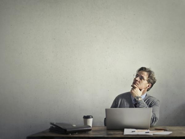 Homme qui réfléchit devant son ordinateur